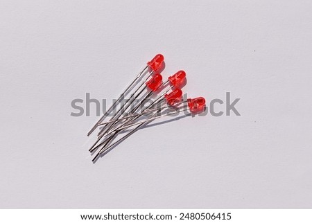 close up of red Light Emitting Diode (LED) electronic components on a white background