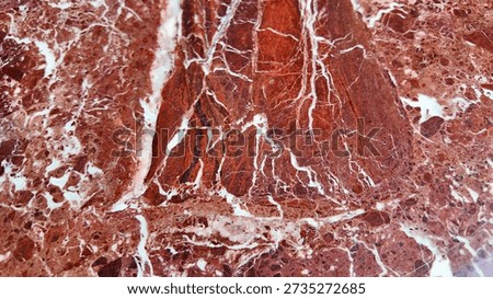 Close up of red marble with white patterns found in nature