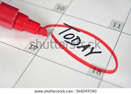close up of a red marker circling a reminder on calendar date