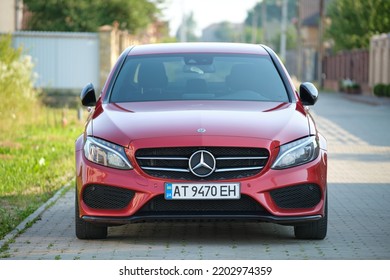 Close Up Of Red Mercedes C 220 D Car Parked On Suburban Street Side. Urban Traffic Concept. Kyiv, Ukraine - July 5, 2021.