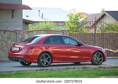 Close Up Of Red Mercedes C 220 D Car Parked On Suburban Street Side. Urban Traffic Concept. Kyiv, Ukraine - July 5, 2021.