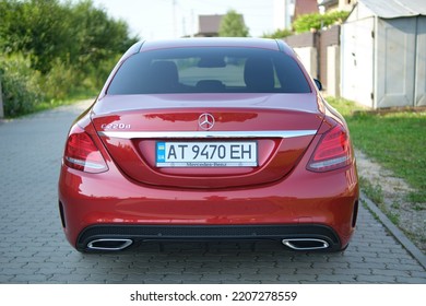 Close Up Of Red Mercedes C 220 D Car Parked On Suburban Street Side. Urban Traffic Concept. Kyiv, Ukraine - July 5, 2021.