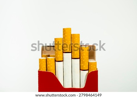 Close up of red pack of cigarettes with yellow filters cigarette addiction nicotine unhealthy close-up abstinence lifestyle