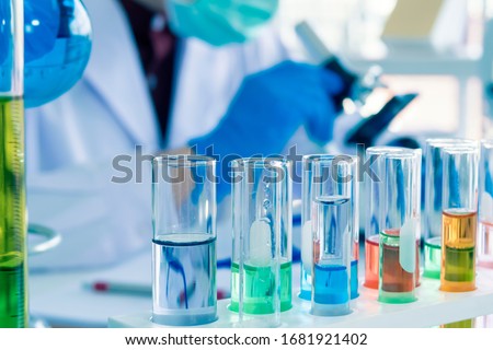 Close up of Red, pink, green, orange blue color liquid medicine in Test tube in rack on chemical table in the modern laboratory room. The education Chemistry and medical science research concept.