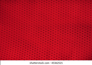 Close Up Of Red Polyester Nylon Red Basketball Sportswear Shorts To Created A Textured Background.