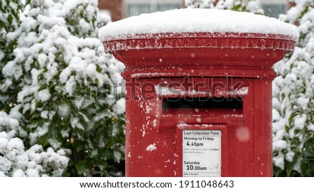Close up of A Red post box in the snow at Christmas