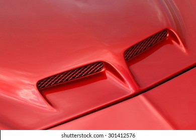 Close Up Of Red Sports Car Hood.