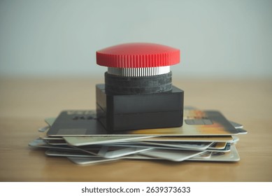 Close up red stop emergency button on many credit card white background. Past due payment or least minimum for credit card, personal financial problem, household debt issues, refinancing concept.