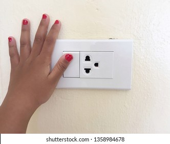 Close Up Red Thumb Finger’s Kid Is Turning On Or Turning Off The Light-switch. Safety Concept.