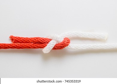 Close Up Red And White Rope Sheet Bend Knot On A White Background.