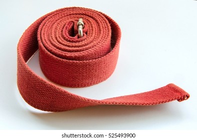 Close Up Of Red Yoga Strap On White Background.