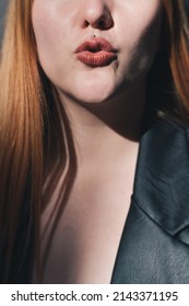 Close Up Of A Red-haired Girl With Red Lips Blowing A Kiss