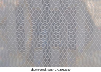 close up of reflective geometric pattern in white street and traffic sign