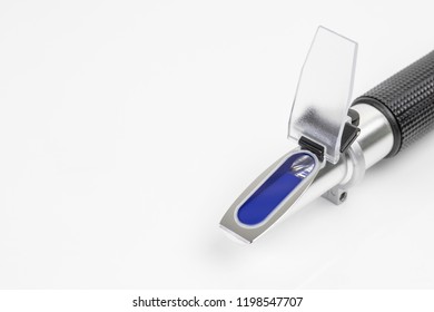 close up refractometer on white background, a laboratory or field device for the measurement of an index of refraction
