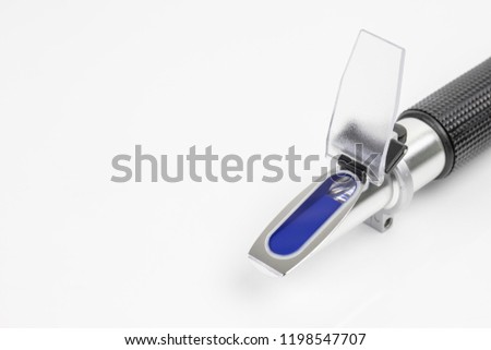 close up refractometer on white background, a laboratory or field device for the measurement of an index of refraction