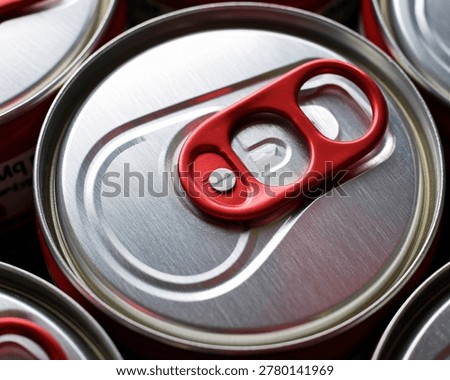 Close up of a refreshing beverage can with a red pull tab