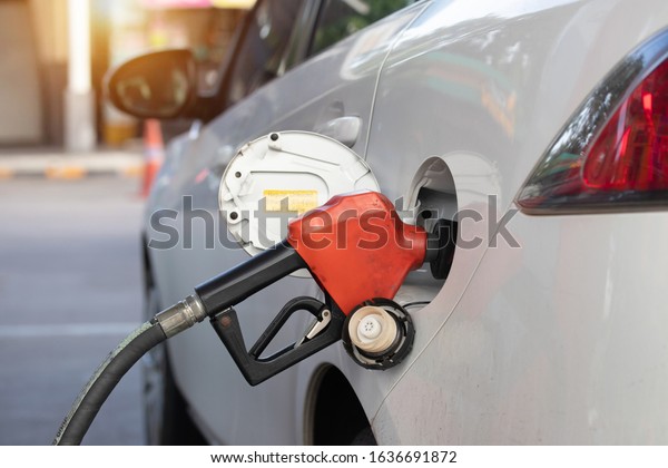 Close up refueling car fill with gasoline at gas\
station. Fuel up car benzine at petroleum station. Refuel petroleum\
to vehicle at gas\
station.