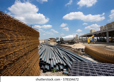Close up of reinforcement mesh on pile and other construction material and equipment at building site - Shutterstock ID 578104672
