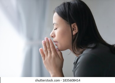 Close Up Of Religious Young African American Woman Hold Hands In Prayer Ask Beg To God. Superstitious Biracial Female Believer Pray Feel Grateful Thankful. Religion, Faith, Superstition Concept.