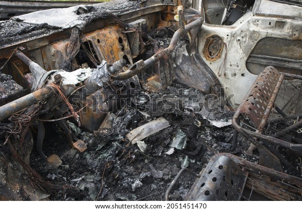 A close up\
of Remains of a burnt van from\
inside