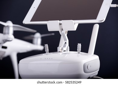 Close up of remote control with tablet attached for drone against black background