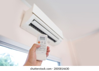 Close up remote set adjust temperature at 25 degrees of air conditioner split type wall mounted in home room concepts of cool or heat air cleaner and service repairing and maintenance.