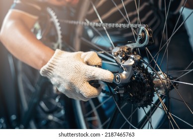 Close Up Repairman Mechanic Working In Bicycle Repair Shop With Bike Tools And Part, Bike Maintenance At Bike Shop, Self Bike Service At Home.