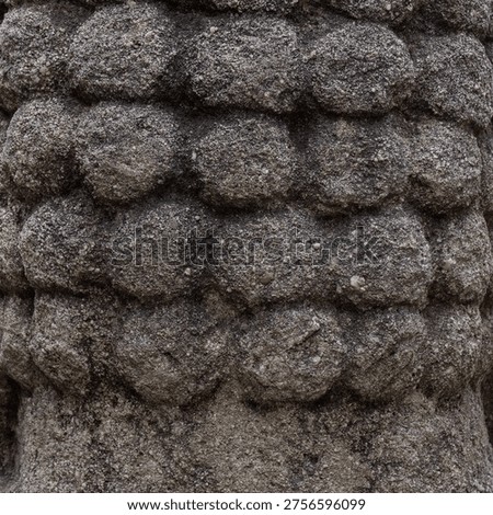 Close up of repetitive round bumpy stone texture with rough weathered surface.