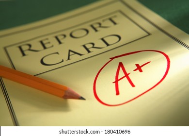 close up of report card with A+ and pencil 