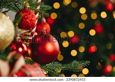 Close up of res shiny balls hanging on Christmas tree