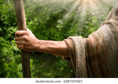 Close up retro rustic tool medieval rural herd devote adult age wise herder worker saint prayer John baptist. Middle east holy jew Joseph robe cloth walk Lord pray hope bible story rod symbol concept