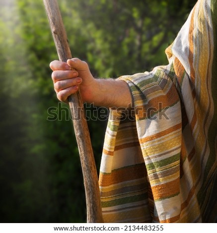 Close up retro rustic tool medieval rural herd devote adult age wise herder worker saint prayer John baptist. Middle east holy jew Joseph robe cloth walk Lord pray hope bible story rod symbol concept