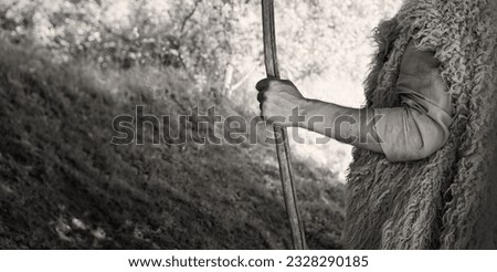 Close up retro rustic tool medieval rural herd devot adult age wise herder worker saint prayer John baptist Middl east holy jew Joseph fur robe cloth walk Lord pray hope bible story rod symbol concept