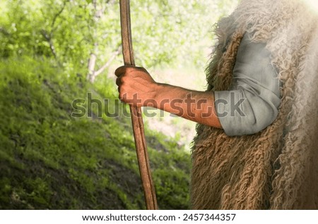 Close up retro rustic tool medieval rural herd devot adult age wise herder worker saint prayer John baptist Middl east holy jew Joseph fur robe cloth walk Lord pray hope bible story rod symbol concept