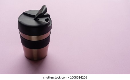 Close Up Of Reusable Coffee Cup On Pink Background From Above