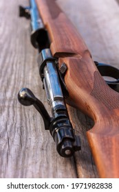 Close Up Of Riffle Bolt. Riffle, Gun On Rustic Wooden Surface 