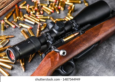 Close Up Of Rifle Scope Hunting On Wooden Ammonition Background. Hunt Sniper Gun, Optics Scopes Close Up.