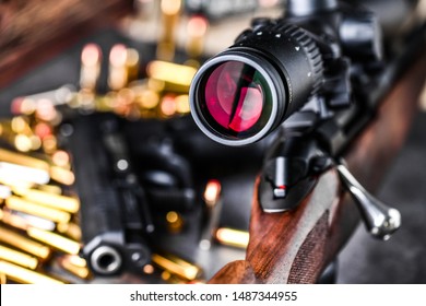 Close Up Of Rifle Scope Hunting On Wooden Ammonition Background. Hunt Sniper Gun, Optics Scopes Close Up.