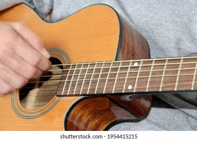 Close Up Of A Right Hand Strumming On A Steel String Acoustic Guitar