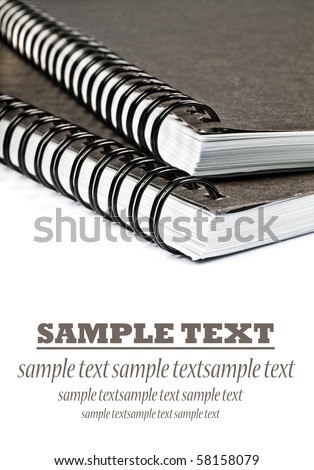 Close up of ringbinded note books on a white background with space for text
