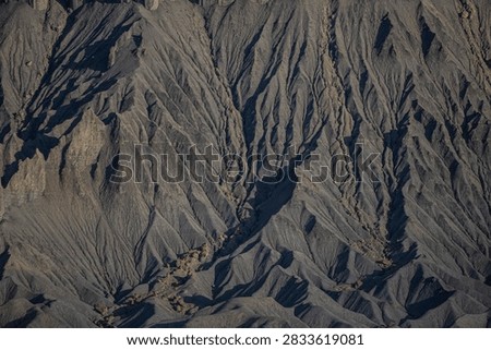 Close up Rippled sand texture of cold gray rocky sandstone of Factory Butte, a huge fortress texture and background, located at east of Capitol Reef National Park, Hanksville in Southern Utah, America southwest, USA 