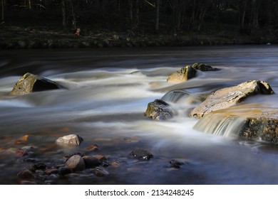 Close Up Of River Rapids Showing Motion Blurred Water. River Wear, Witton Le Wear, County Durham, England, UK.