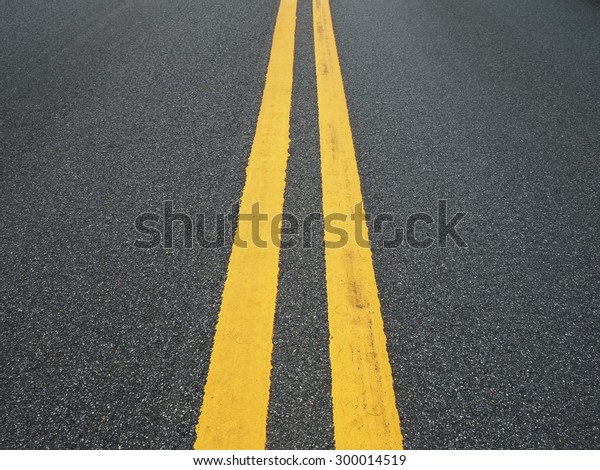 Close up road divide\
yellow twin line