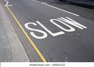 Close Up Of Road Marking Saying Slow In London, UK