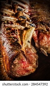 Close Up of Roasted Rectangle Rack of Lamb Chops or Guard of Honor on Black Background