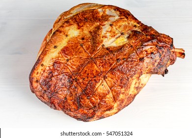 Close Up Roasted Whole Ham On Wooden White Background