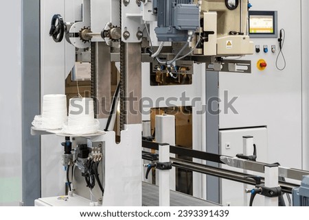 Close up roll of thread and thread feeder kit component for bag sewing closures of of automatic weighing bag filling packing machine in industrial