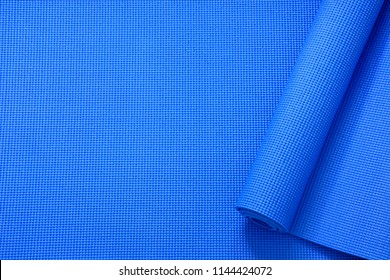 Close Up Rolled Blue Color Yoga Mat Texture Background,top View, Copy Space, Healthy Lifestyle, Sport And  Exercise Concept