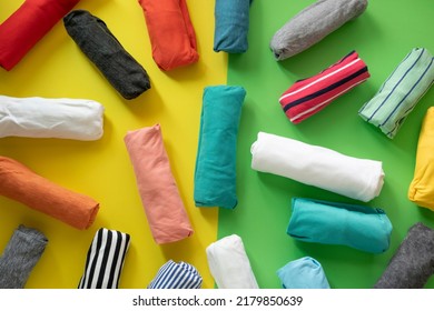 Close Up Of Rolled Colorful T Shirt Clothes On Table Background, Travel Concept