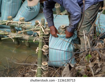 Close Up Of A Rope Bamboo  Structure And Sandbag. For Security In Constructing Small  Water Reservoir Of The People Of Northern Thailand.